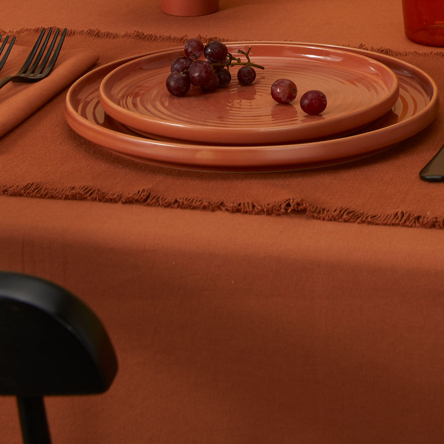 Essential Cotton Tablecloth in Terracotta with place setting.