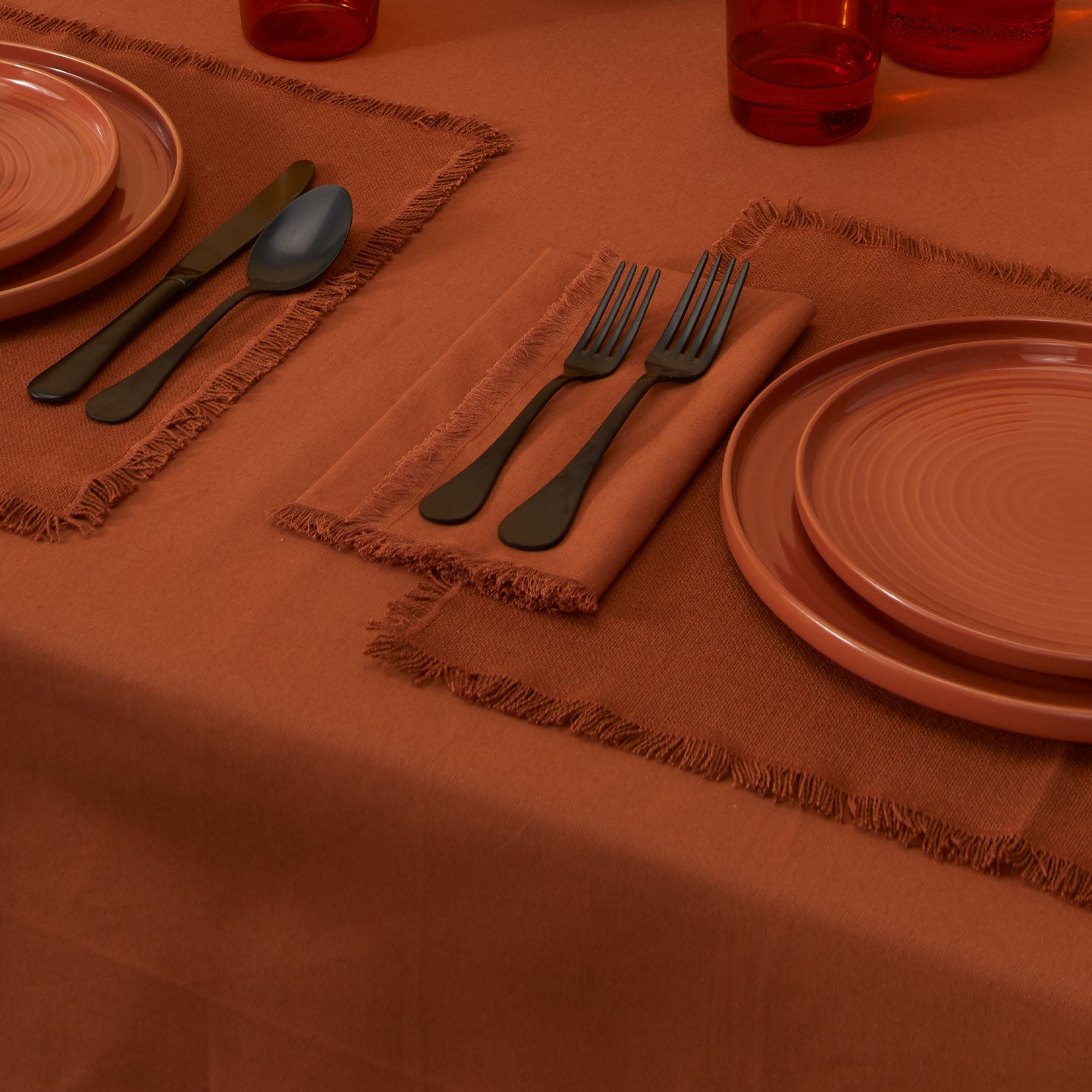 Essential Dinner Napkins in Terracotta on table.