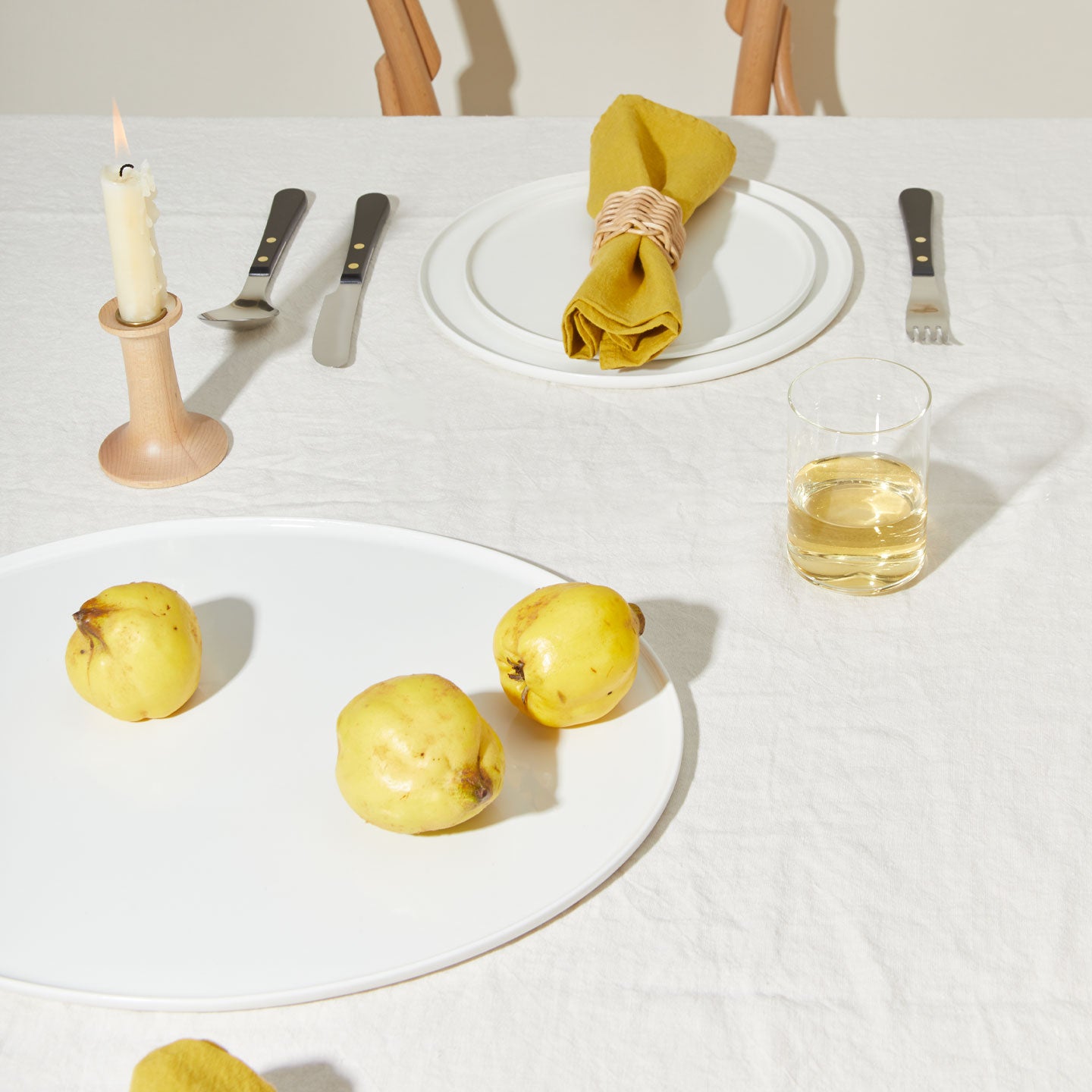 Table setting with Simple Porcelain Dinnerware, Simple Glassware, Simple Linen Napkins, and Provencal Flatware.