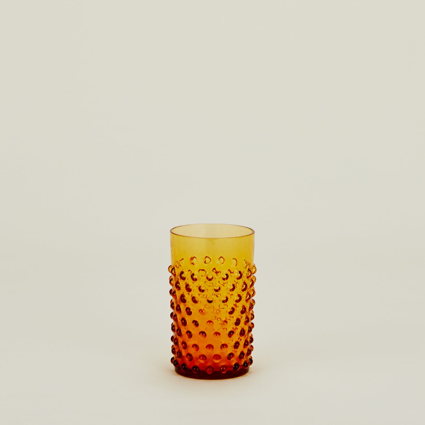 Textured amber glass tumbler.