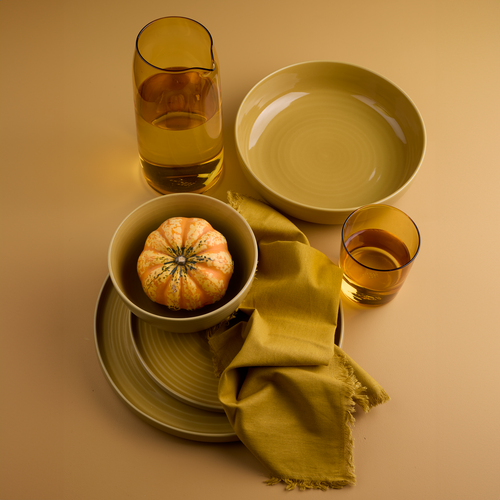 Essential dinnerware, glassware, pitcher, and napkins in Mustard tones.