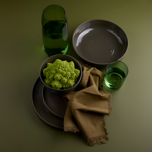 Essential dinnerware, glassware, pitcher, and napkins in Olive tones.