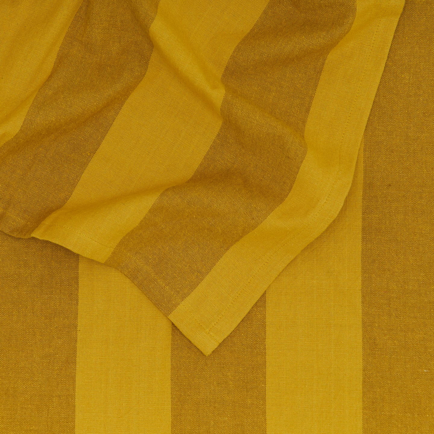 Close up of Essential Striped Tablecloth in Mustard and Bronze.