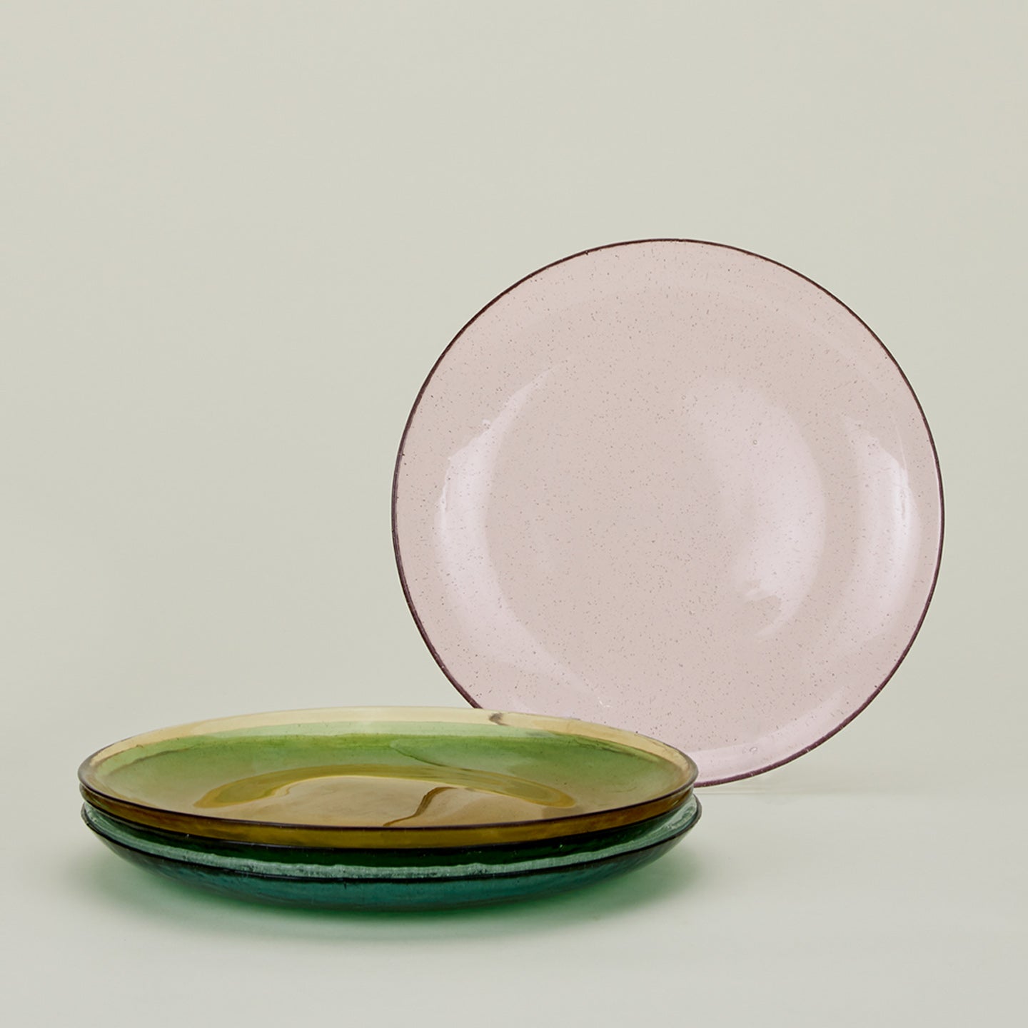 Group of Glass Dinner Plates in various colors.