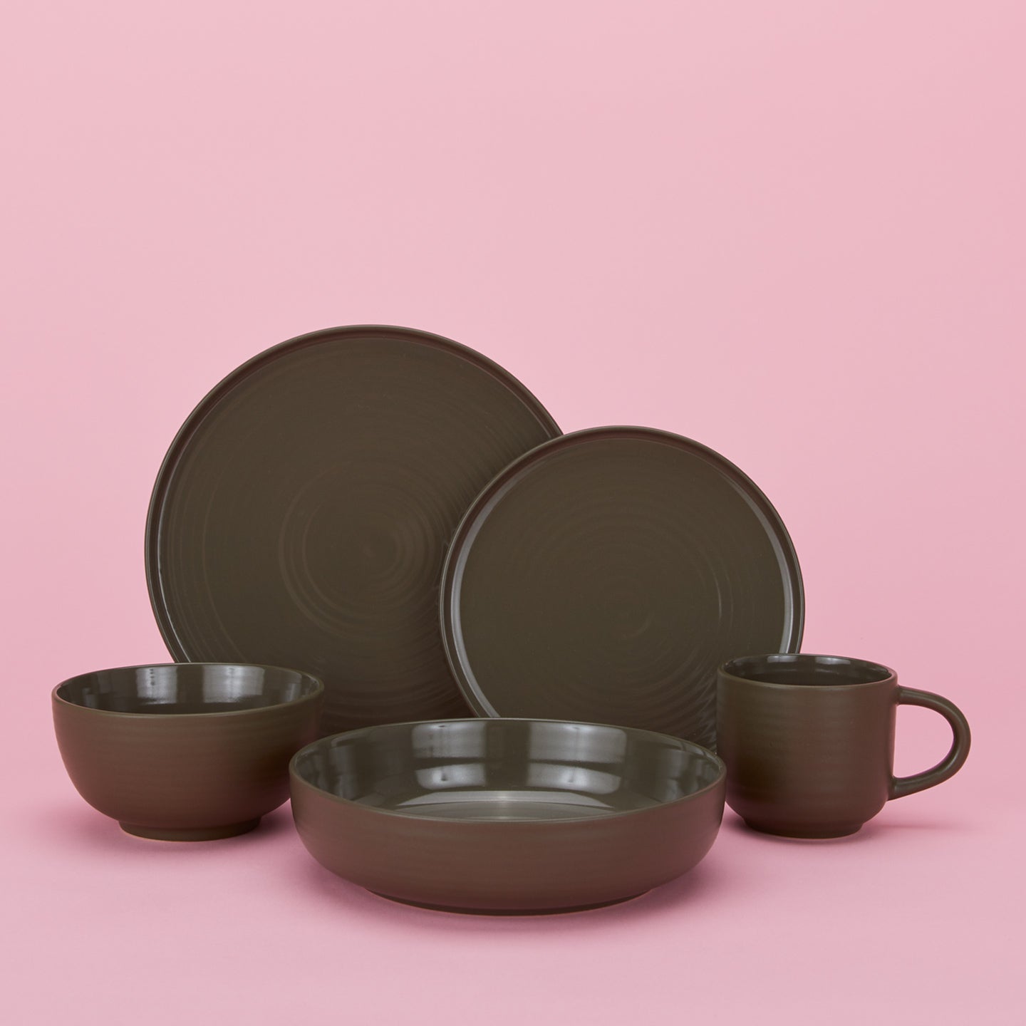 Group of Essential Dinnerware in Olive including low bowl, large bowl, salad plate, dinner plate and mug.