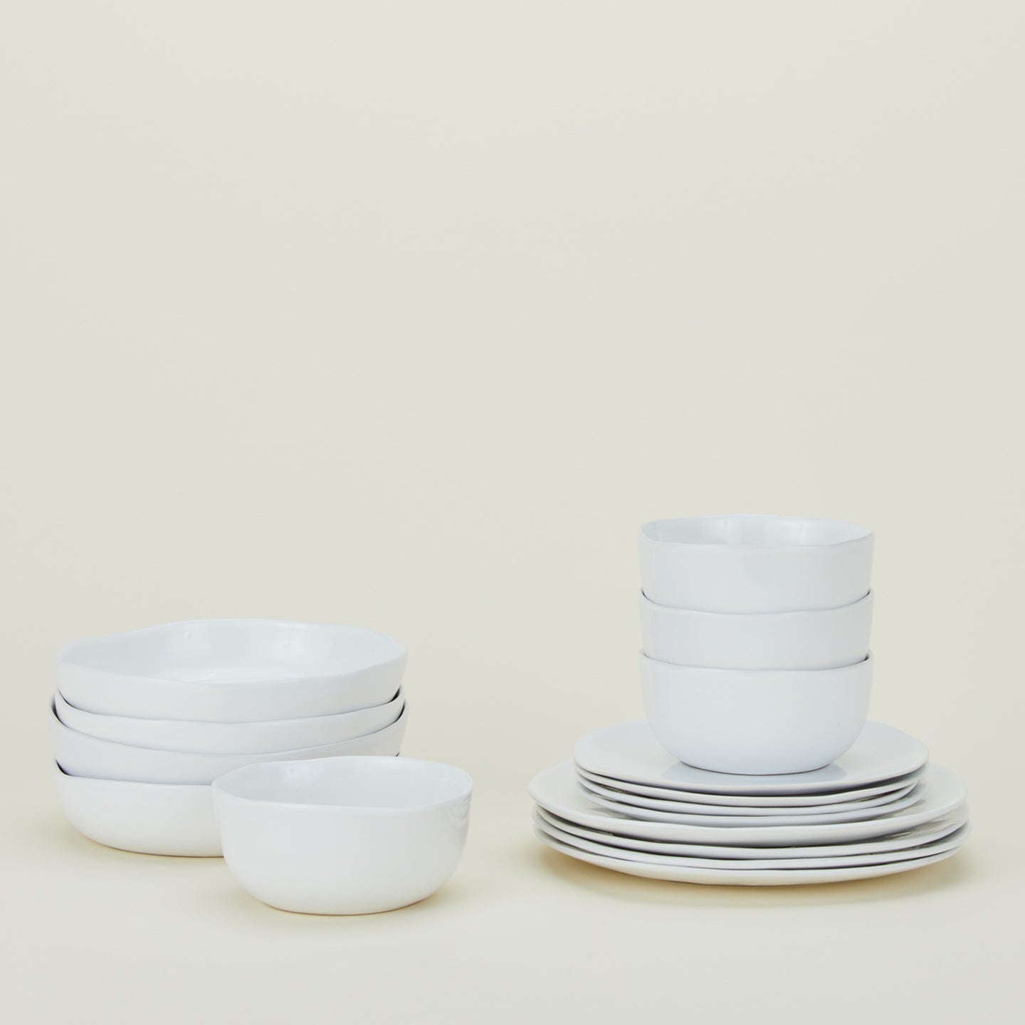 Set of white Strata dinnerware including Large Bowls, Low Bowls, Salad Plates, Dinner Plates and Mugs.