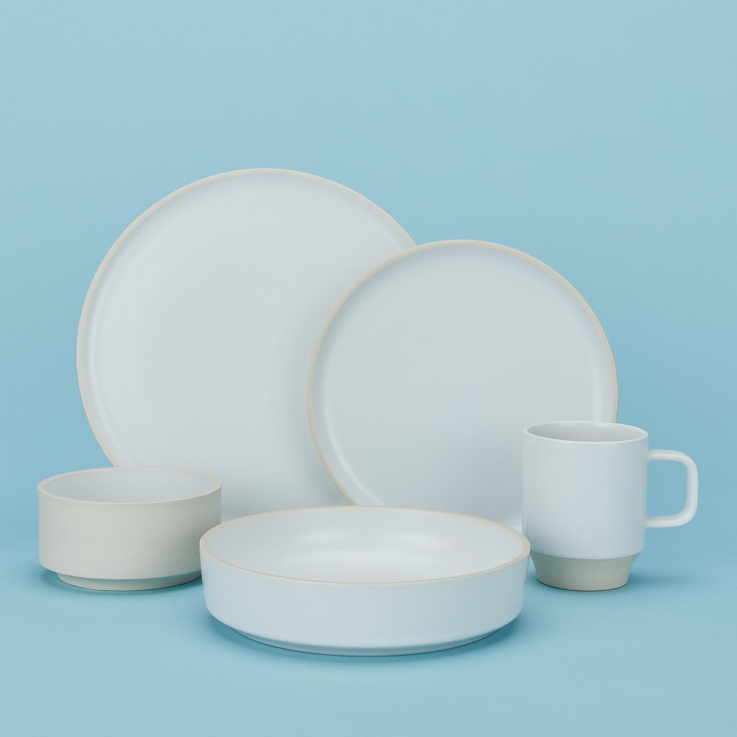 Group of Modernist Dinnerware including low bowl, cereal bowl, salad plate, dinner plate and mug.
