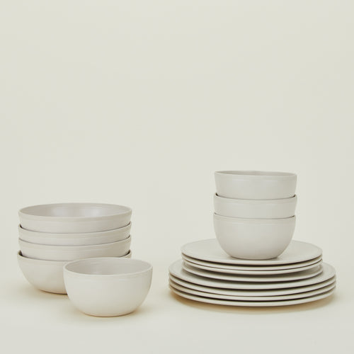 Stacked group of Atelier Dinnerware including four each small bowls, medium bowls, salad plates and dinner plates.