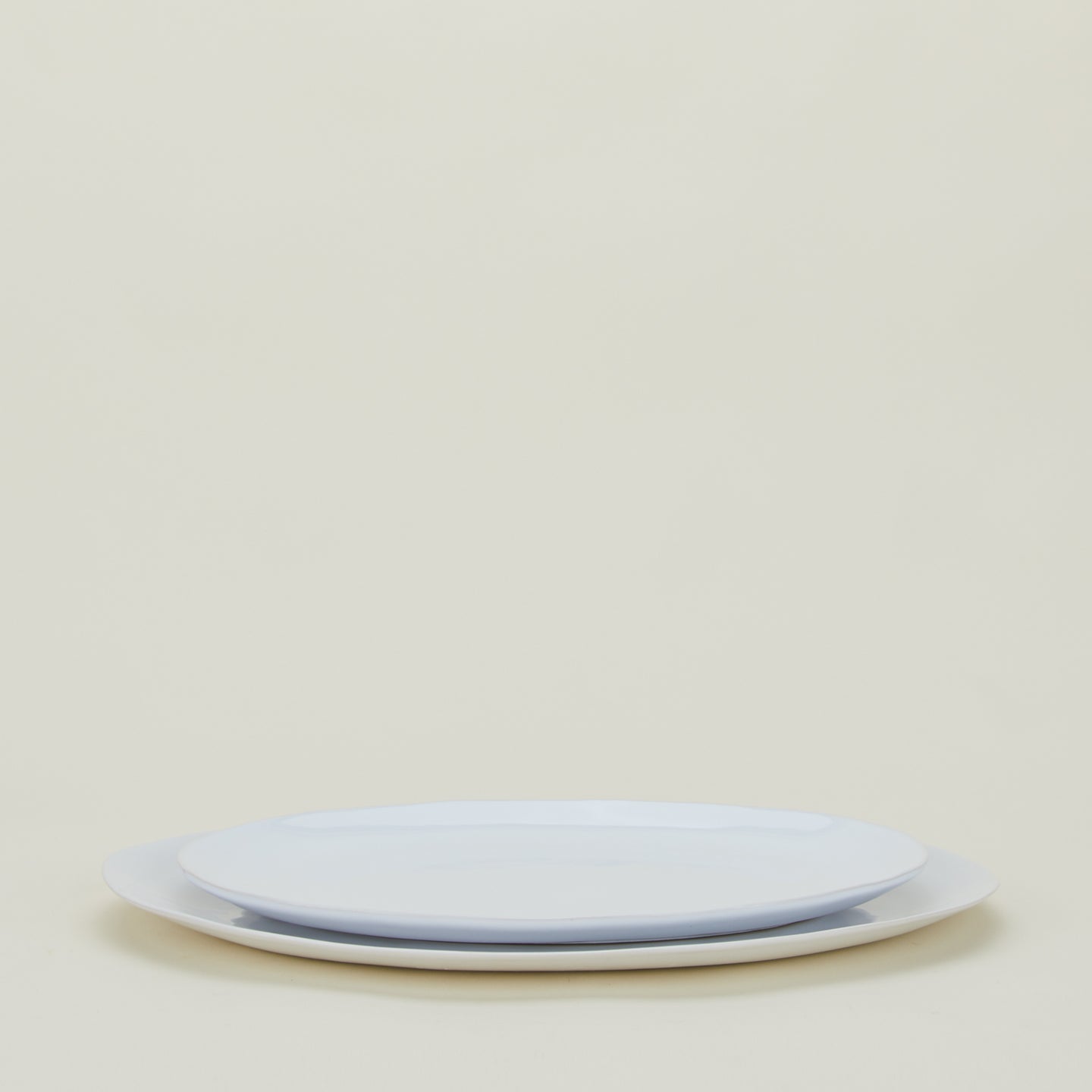 White Strata Serving Platter in two sizes stacked.