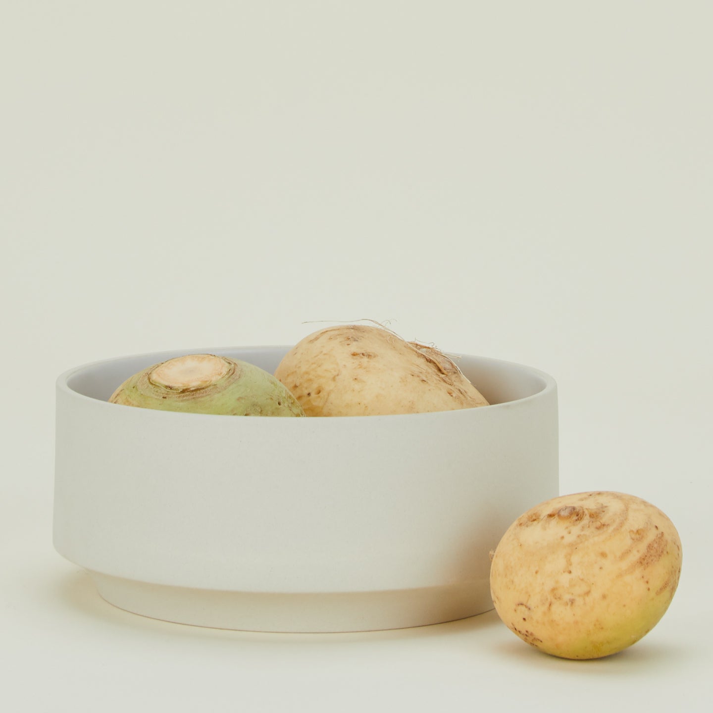 Modernist Serving Bowl filled with root vegetables.