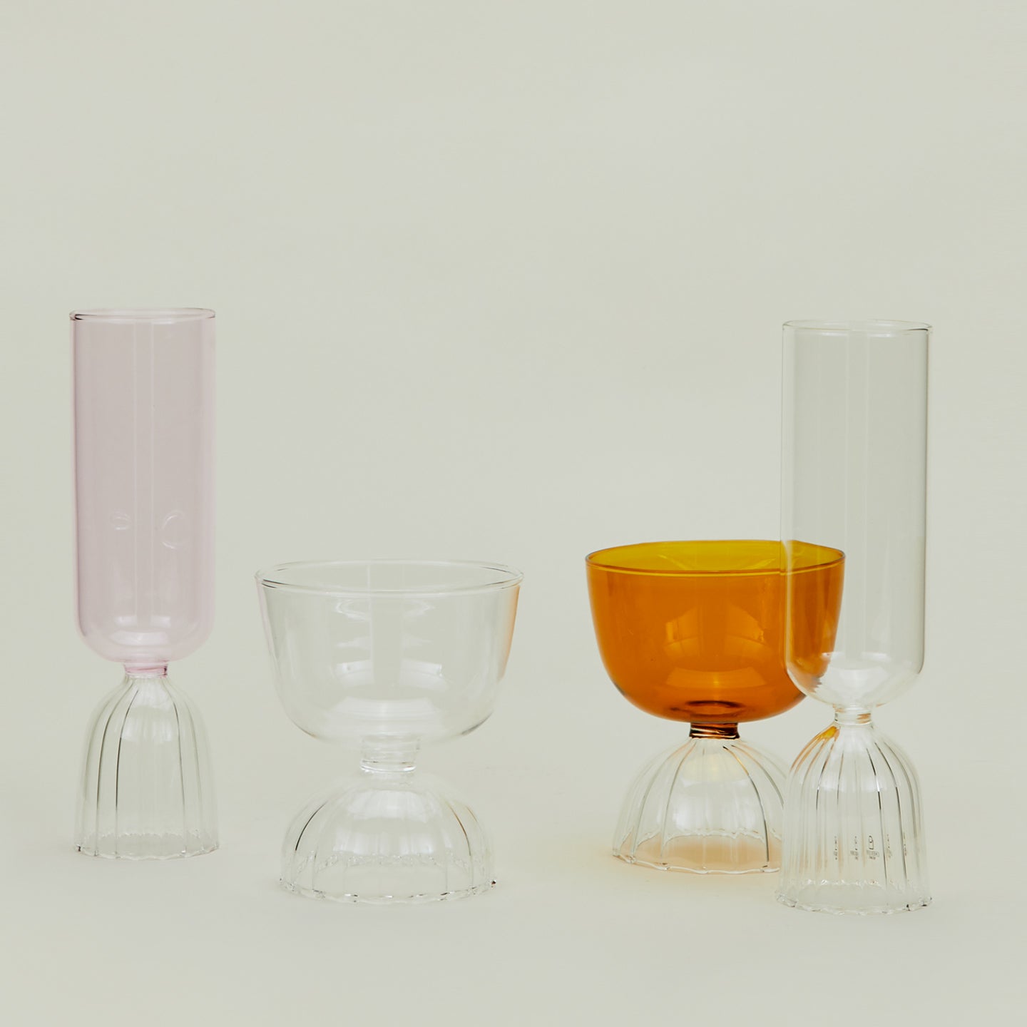 Group of Tutu glassware in various sizes and colors.