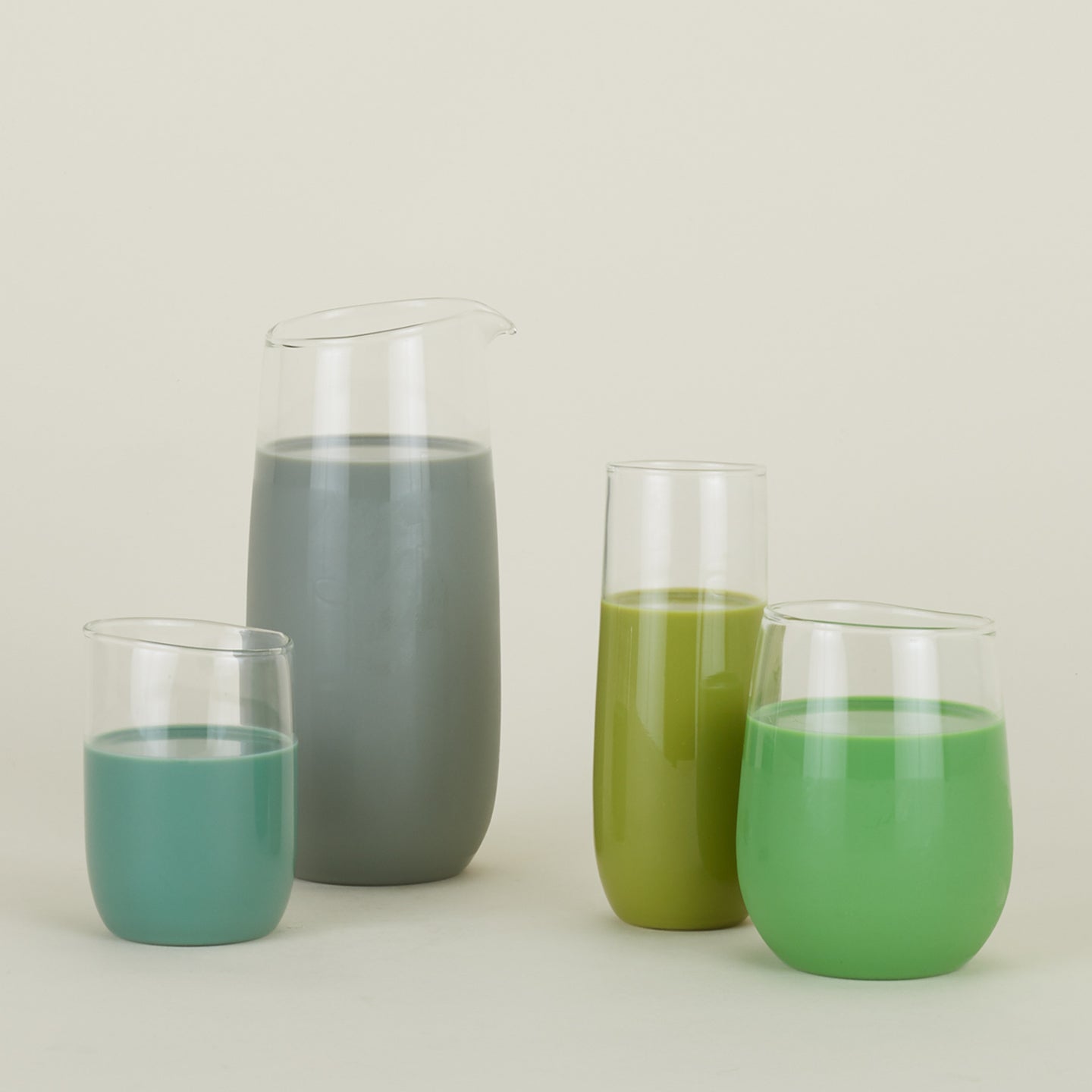 Various clear Boreal glassware pieces filled with green liquids.