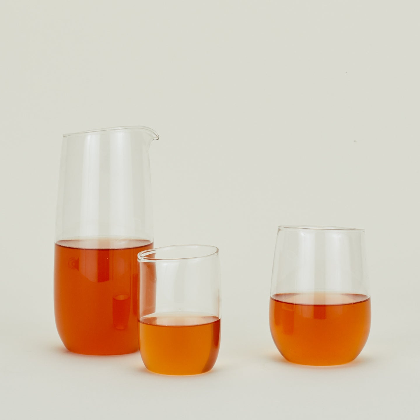 Various clear Boreal glassware pieces filled with orange liquid.