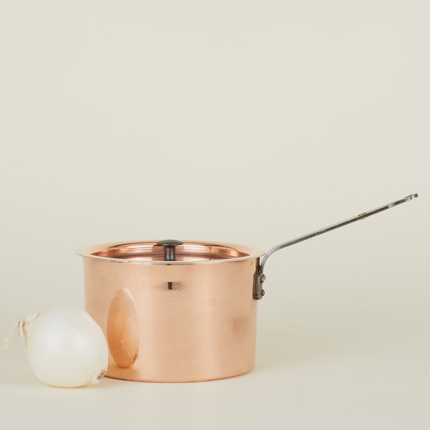 Large copper saucepan with onion