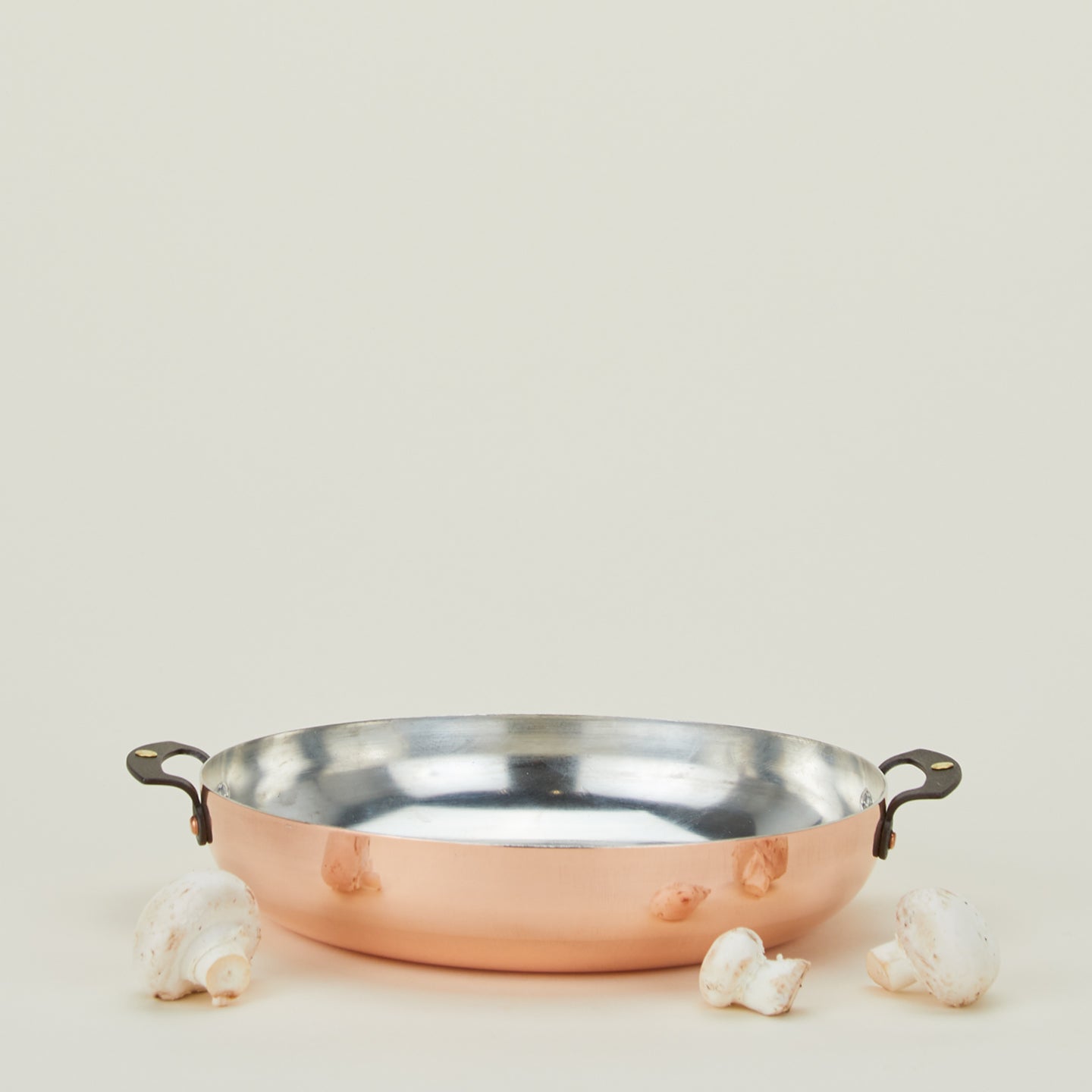 Copper two handled sautee pan with mushrooms