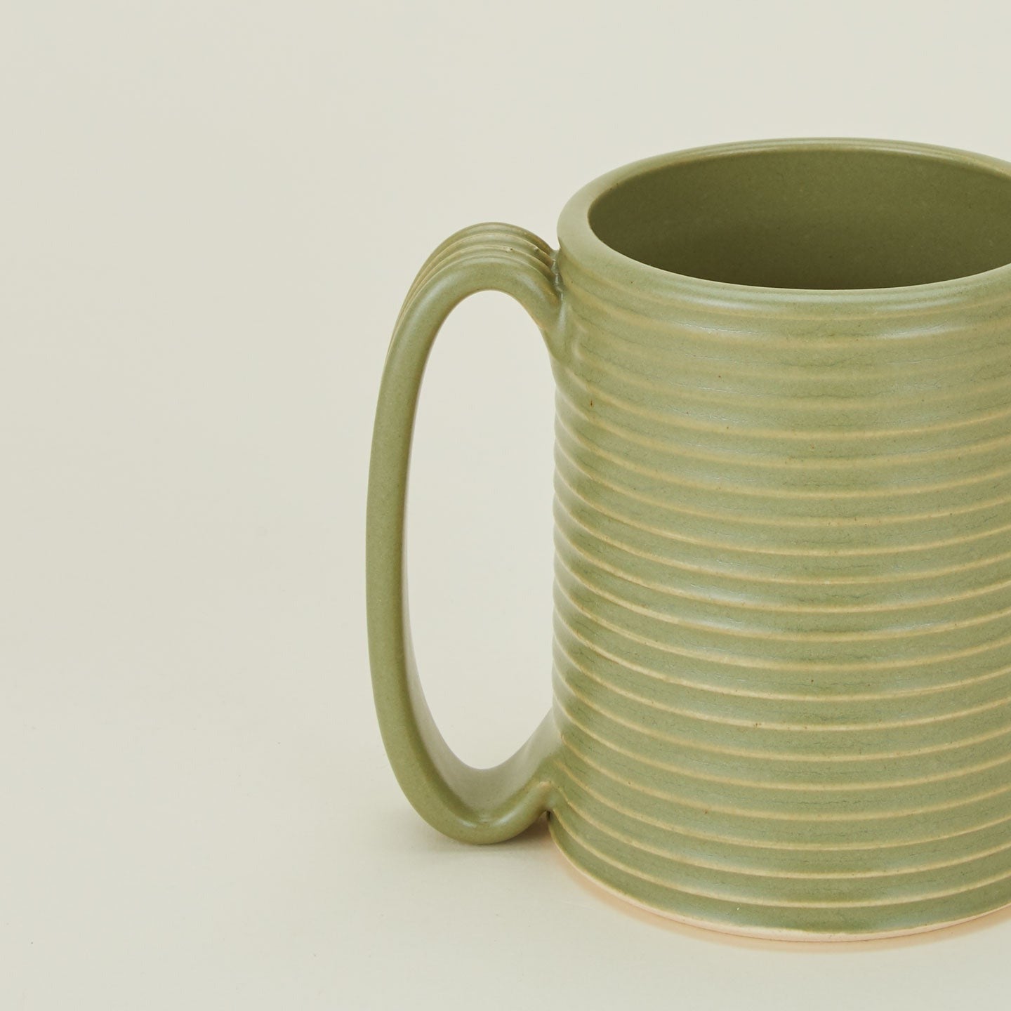 Close up of a Tall Ribbed Mug in Olive.