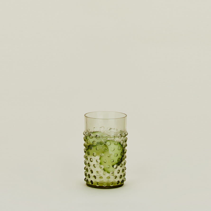 Hobnail Tumbler in Olive filled with water and cucumbers.