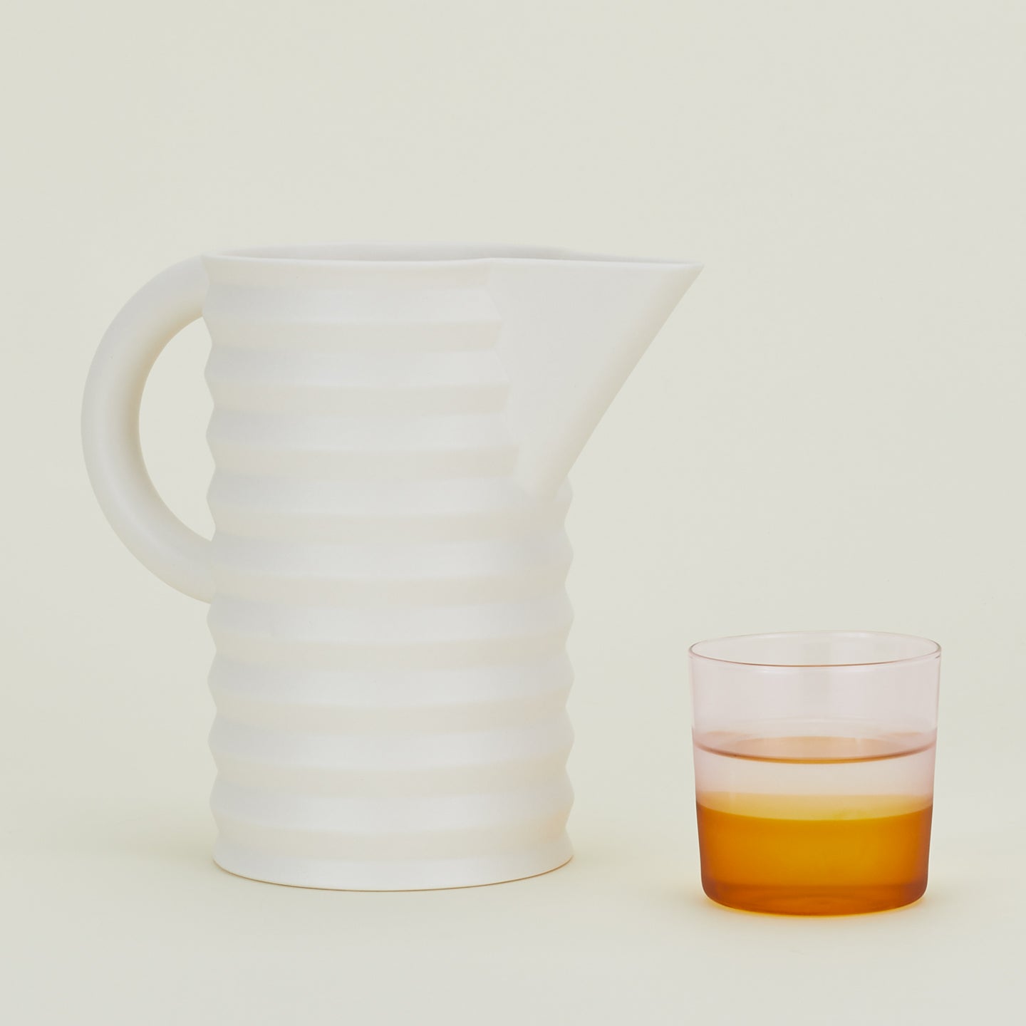 Pleated Pitcher along with a drinking glass.