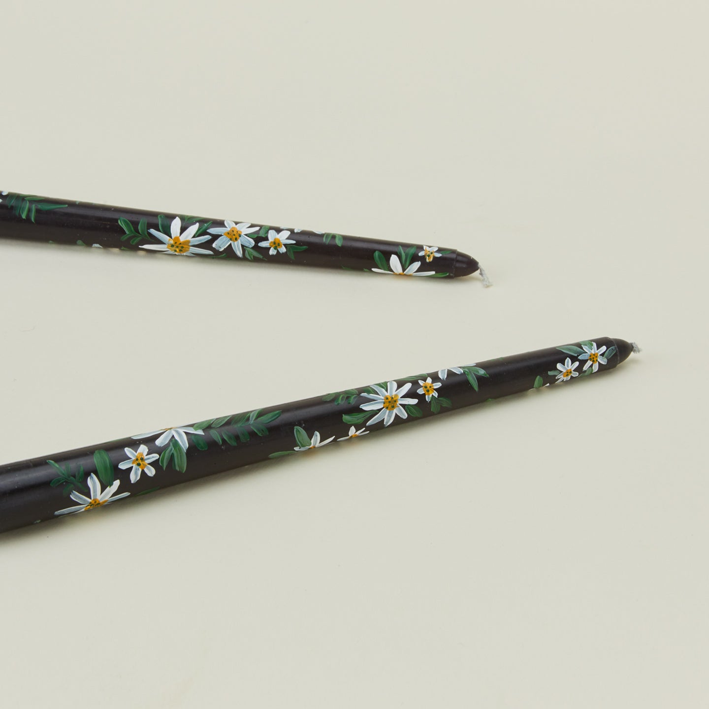 Detailed view of Ashley Myers floral tapers in black