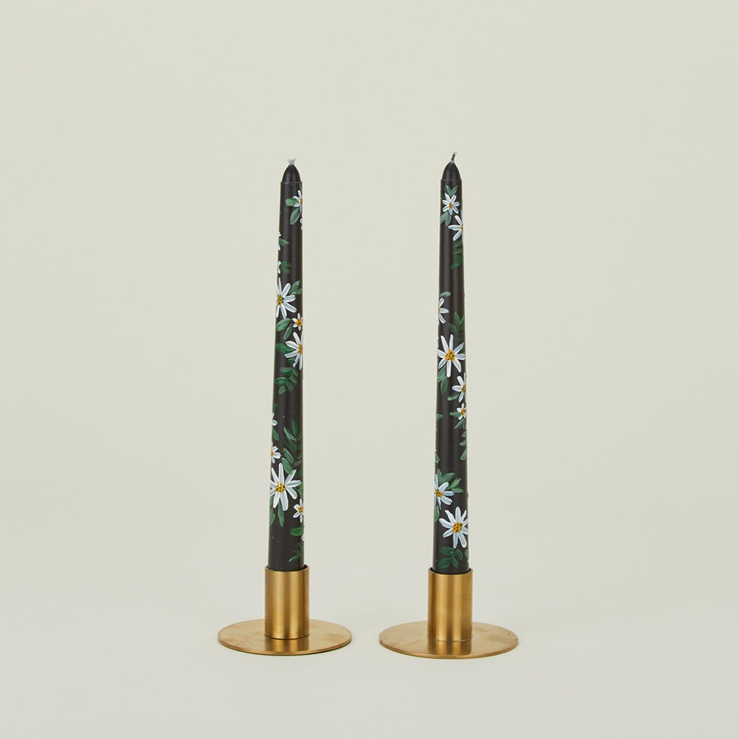 Ashley Myers floral tapers in black in brass candle holders