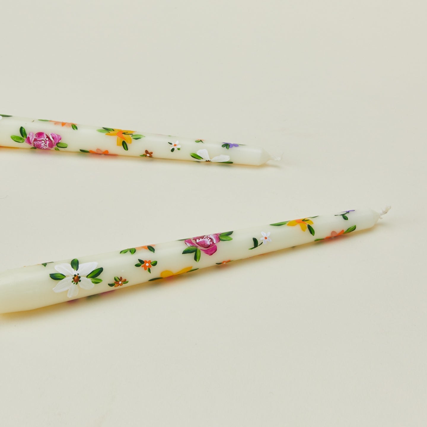 Detailed view of Ashley Myers floral tapers in white