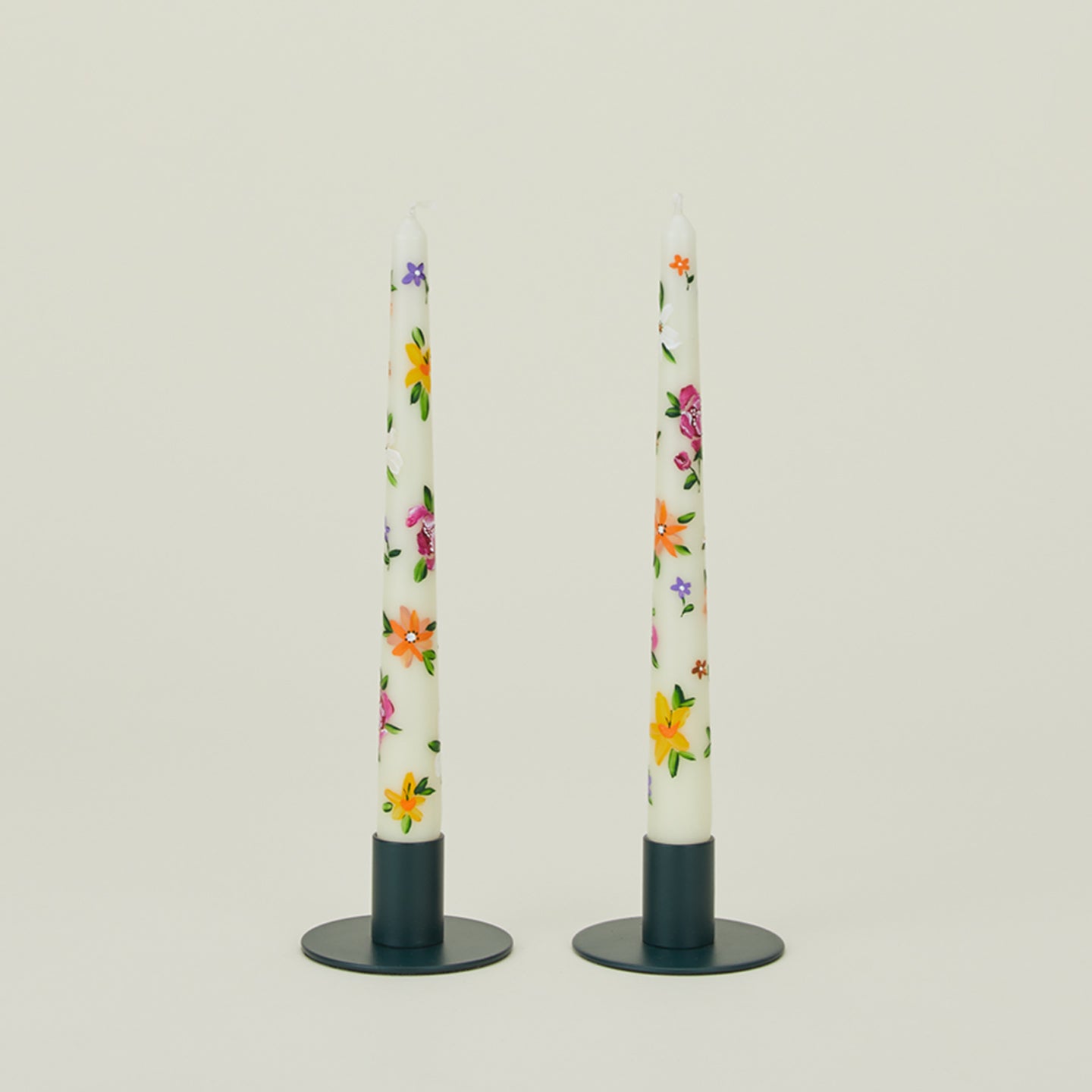 Ashley Myers floral tapers in white in peacock candle holders