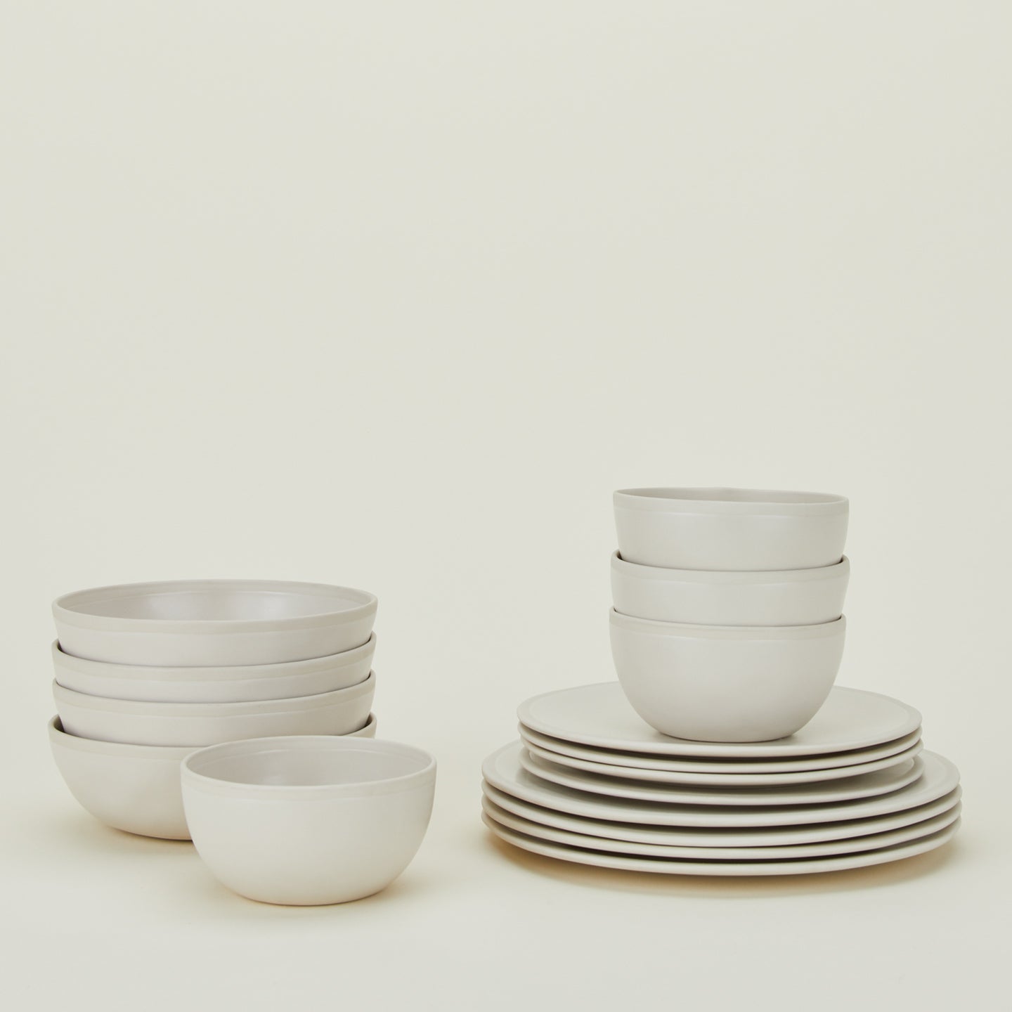 Stacked group of Atelier Dinnerware including four each small bowls, medium bowls, salad plates and dinner plates.