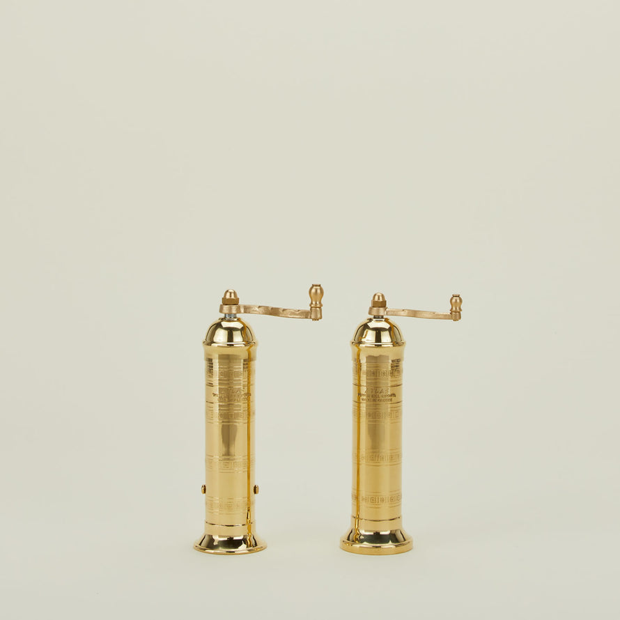 A pair of brass salt and pepper mills.