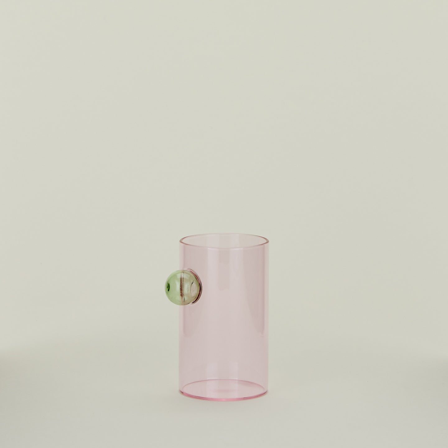 Blush glass with green bubble decoration.