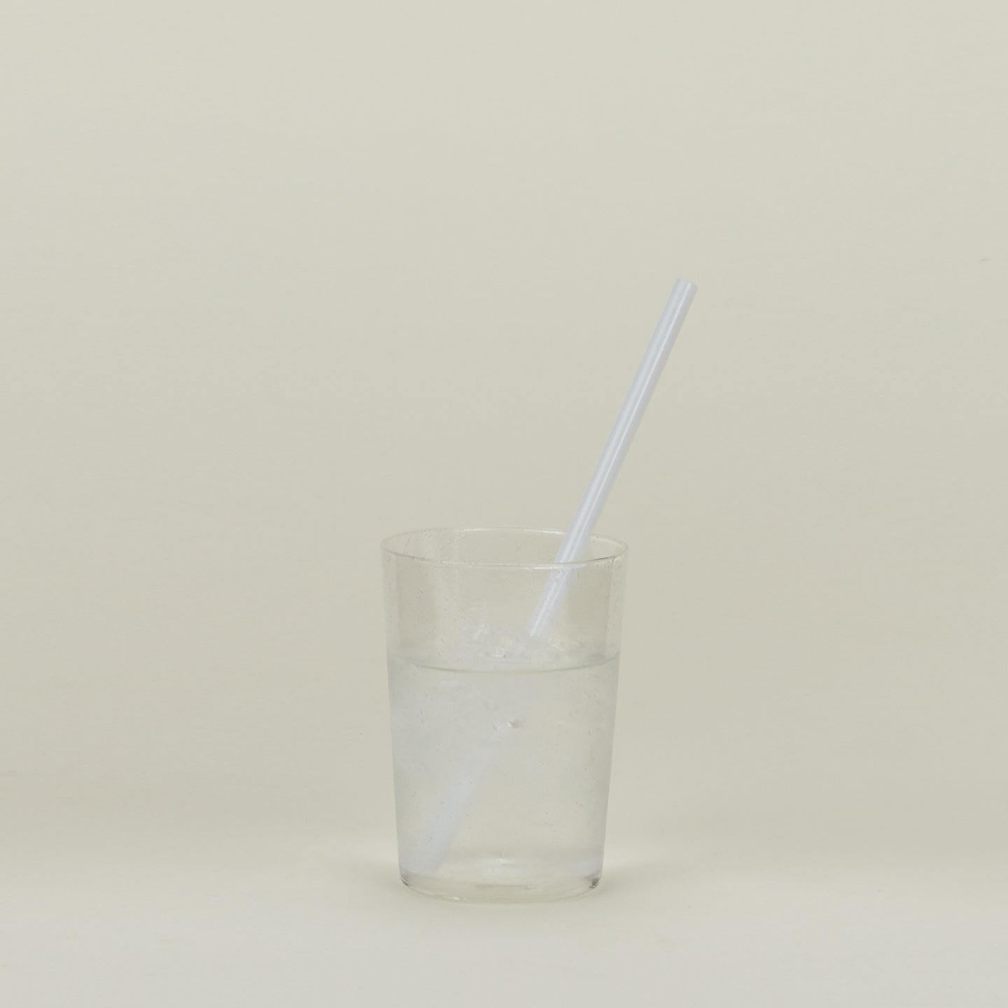 Glass Tumbler in Clear with straw and water.