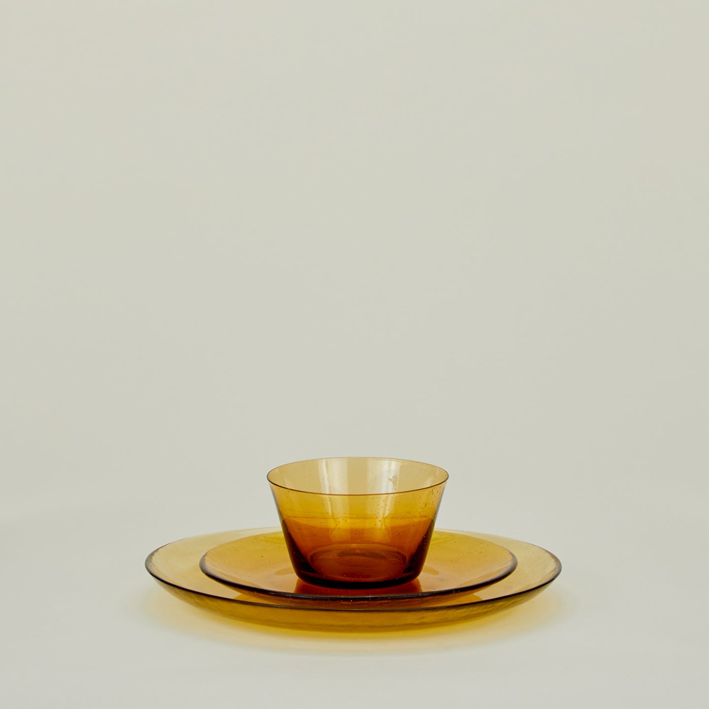 Group of Amber glass salad plate, dinner plate and bowl.