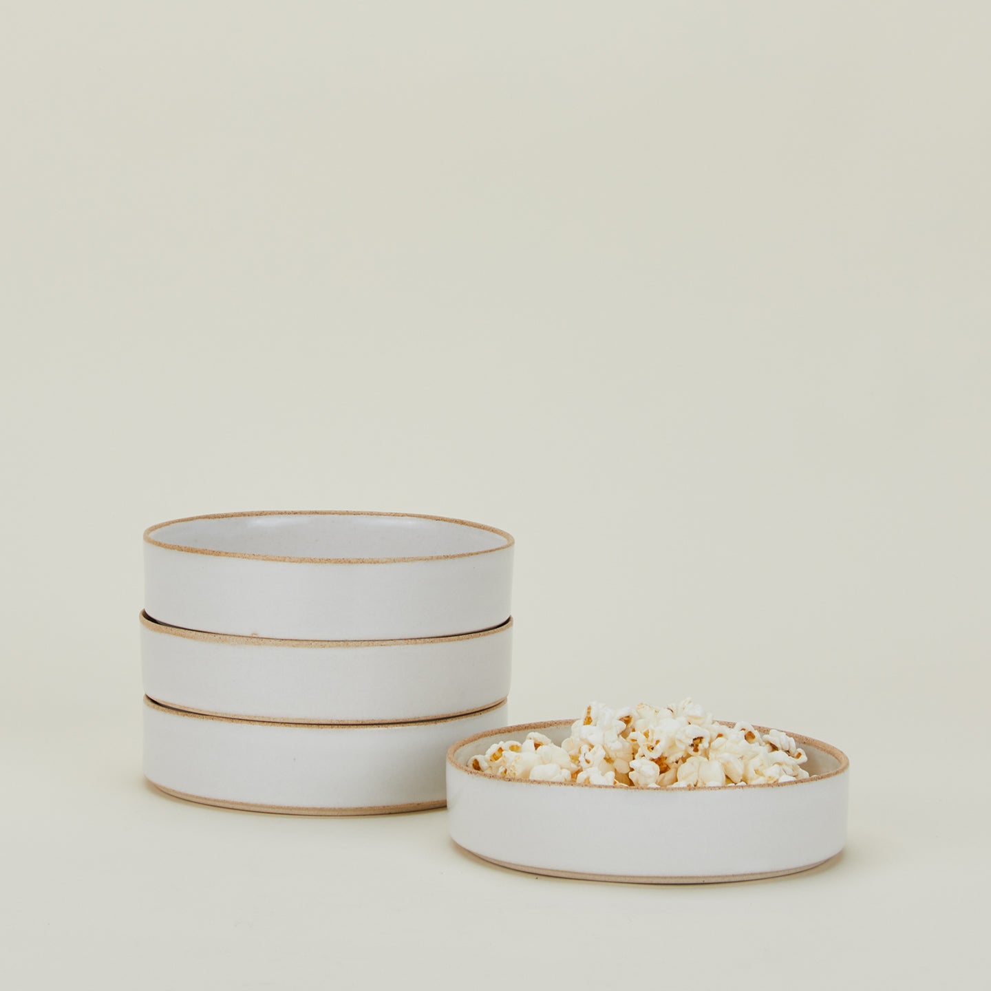 Four Minimal Bowls with popcorn.