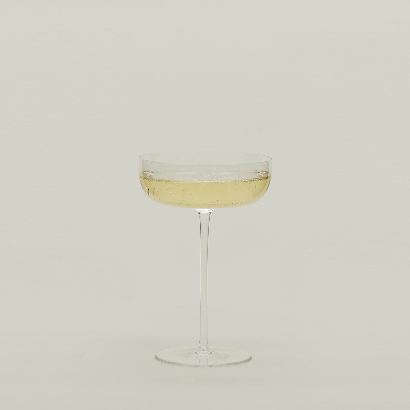 Crystalline Champagne Coupe filled with sparkling wine.