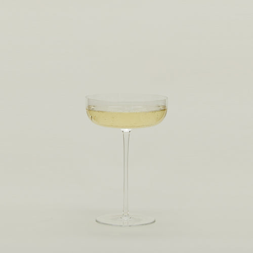 Crystalline Champagne Coupe filled with sparkling wine.