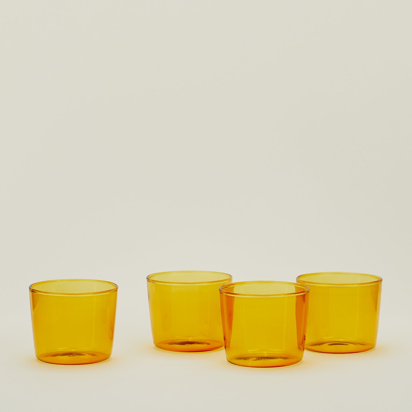 Four Small Essential Glasses in Amber.