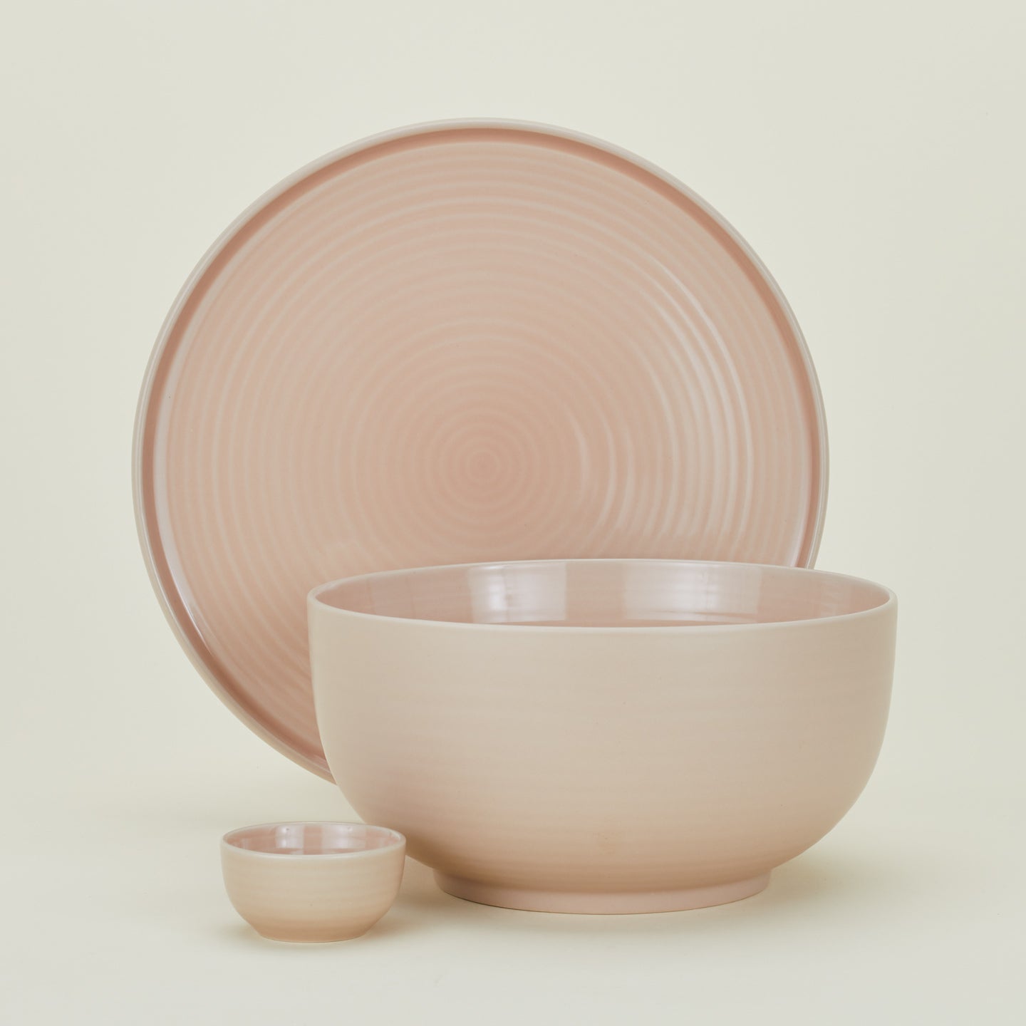 Group of Essential serving pieces in Blush including bowl, platter and extra small bowl.