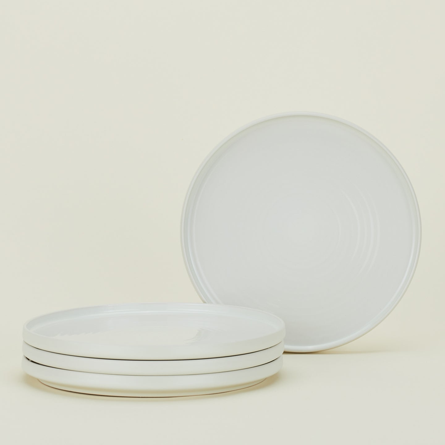 Four bone white Essential Dinner Plates.