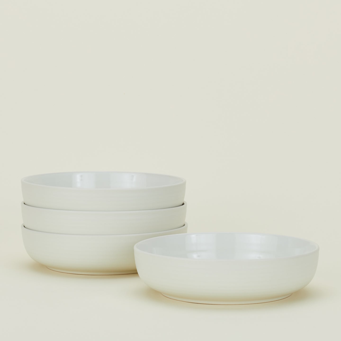 Four bone white Essential Low Bowls.