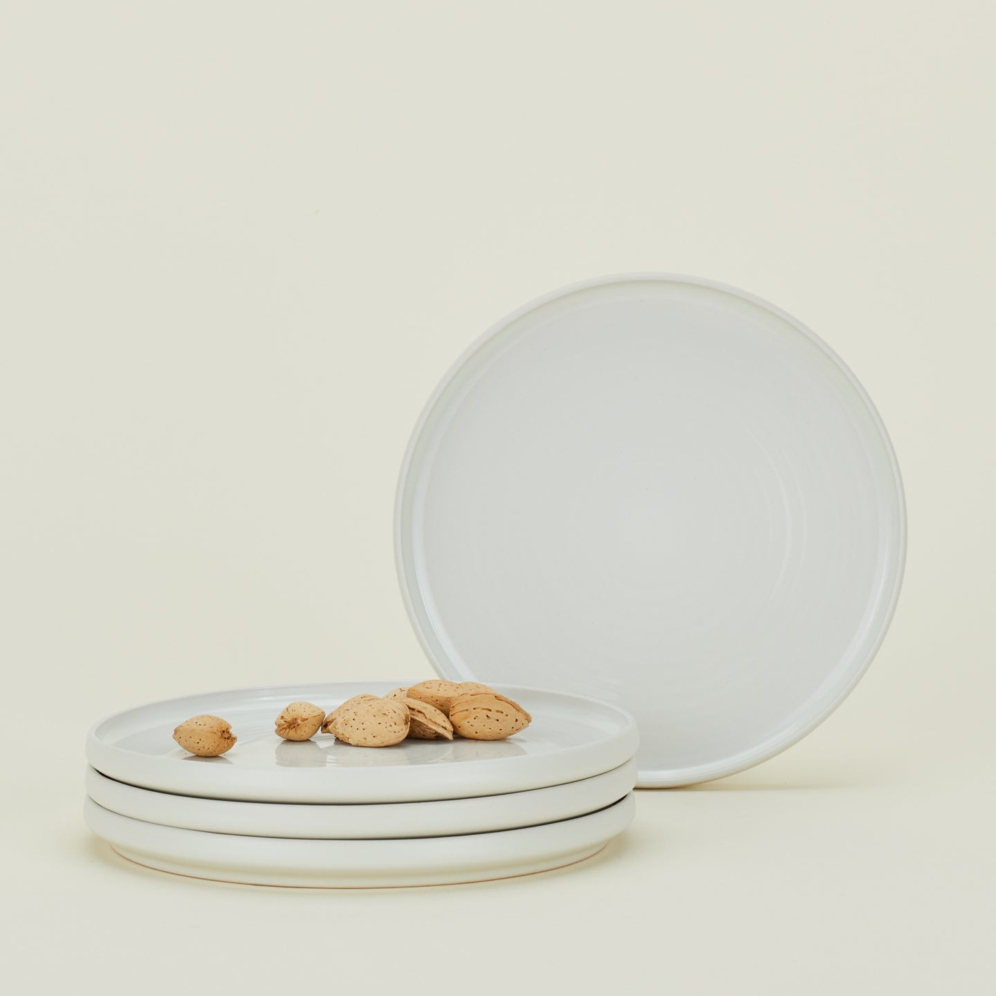 Four Essential Salad Plates in Bone, with nuts.