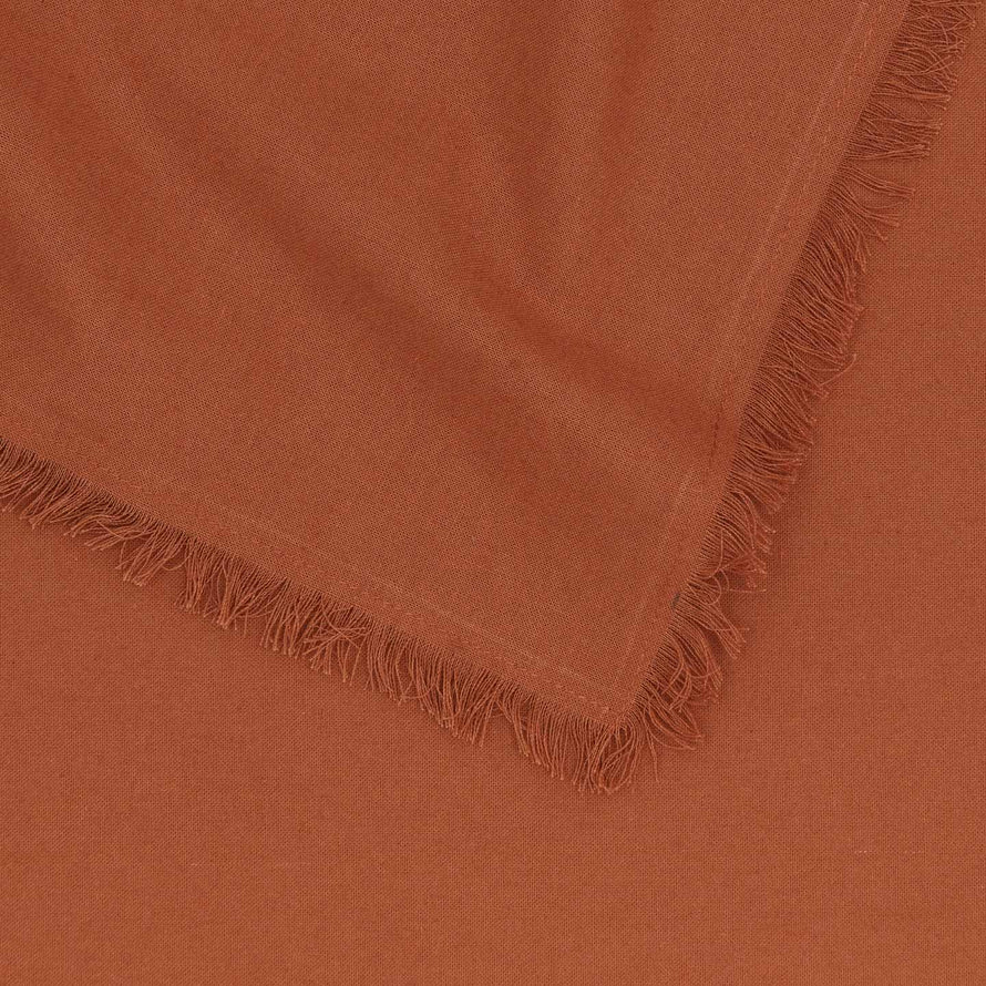 Close up of Essential cotton tablecloth in terracotta.