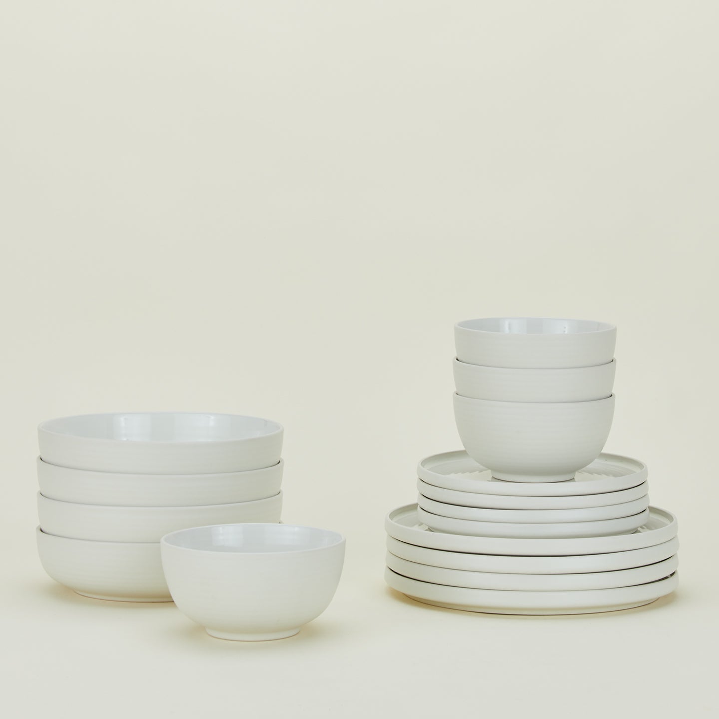 Set of bone white Essential dinnerware including Large Bowls, Low Bowls, Salad Plates and Dinner Plates.