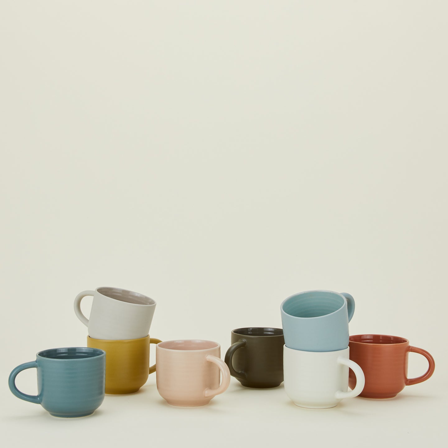 Group of Essential Mugs in various colors.