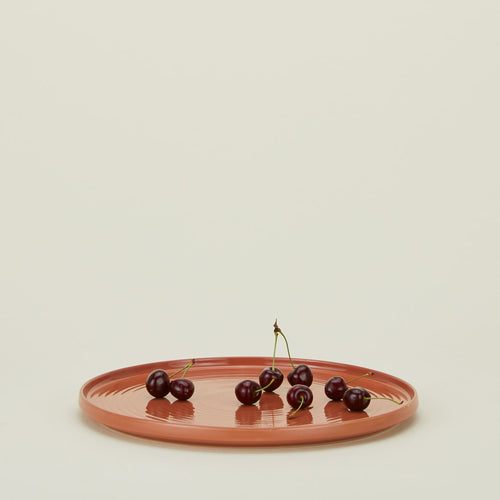 Essential serving platter in terracotta with cherries