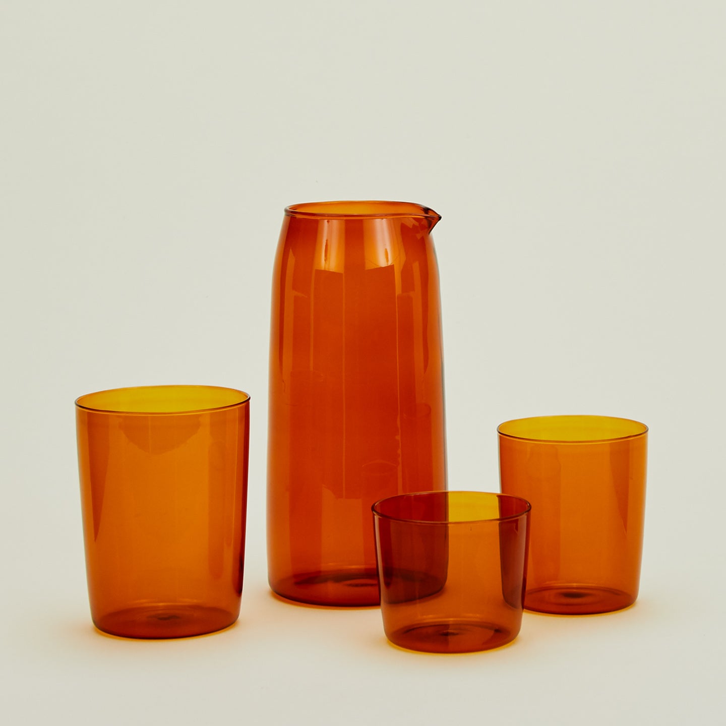 Small, Medium and Large Essential Glasses with Essential Glassware Pitcher in Terracotta.