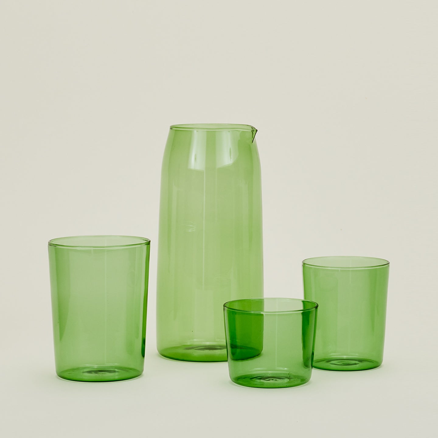 Small, Medium and Large Essential Glasses with Essential Glassware Pitcher in Green.