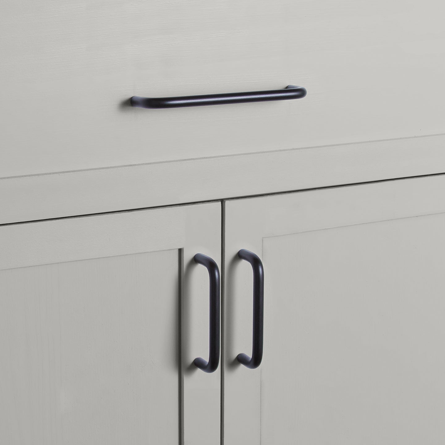 Large and small black pulls on drawers and cabinets