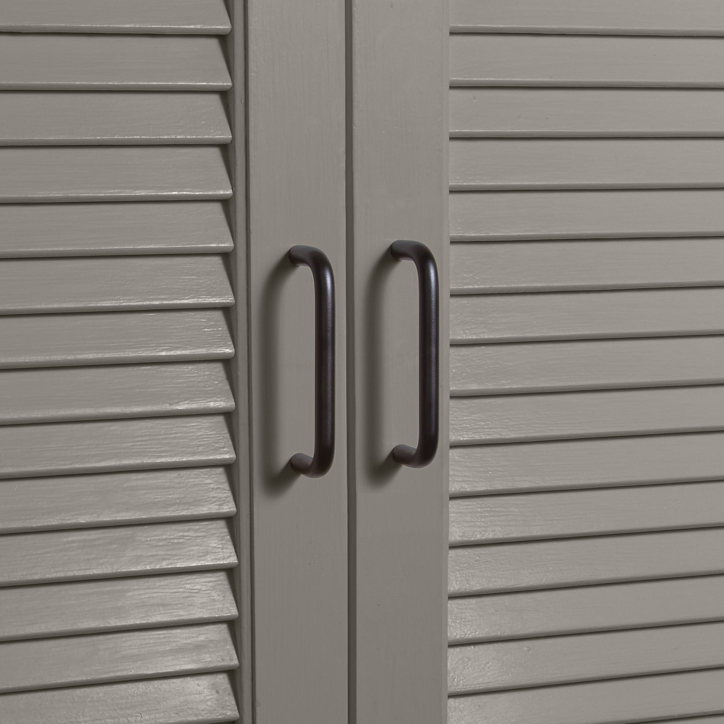 Small black pulls on louvered doors