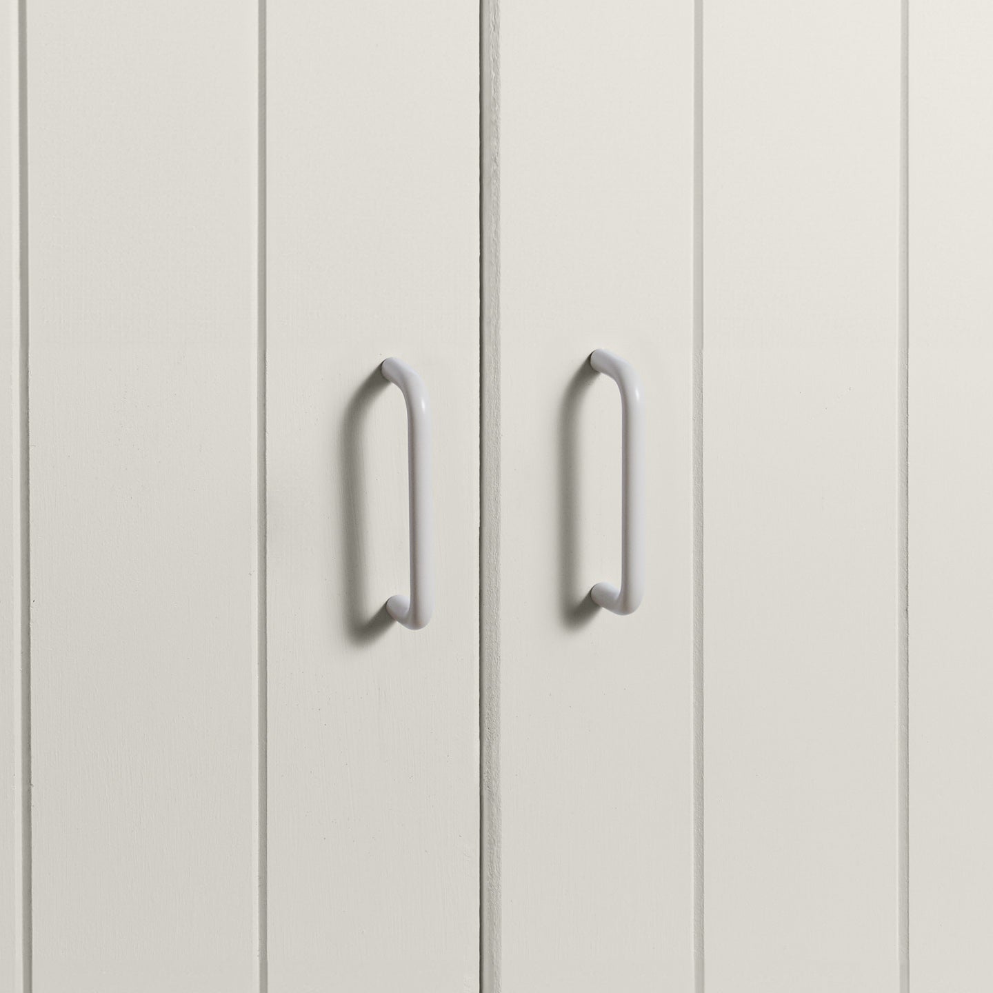 Small ivory pulls on white doors