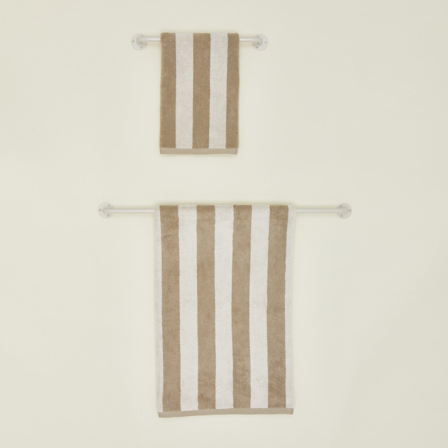 Small and large towel bars in Ivory with striped towels.