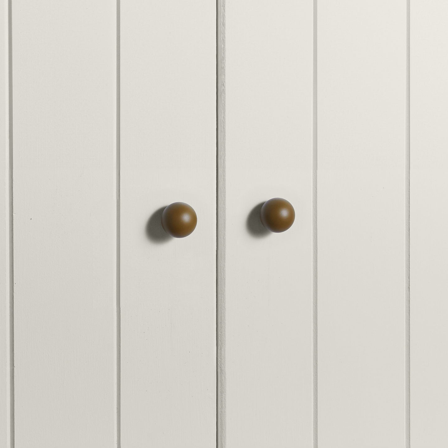 Small olive essential sphere knobs on white doors